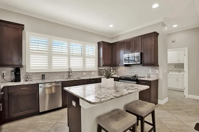 a kitchen with a stove a sink a microwave and cabinets