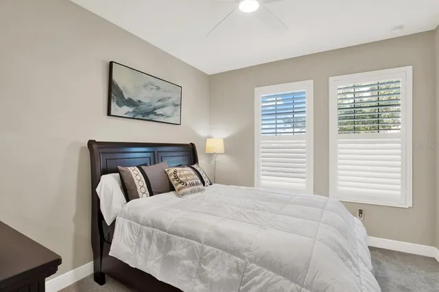 a bedroom with a large bed and a window