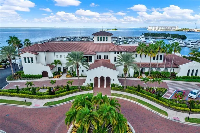 an aerial view of multiple houses with a yard