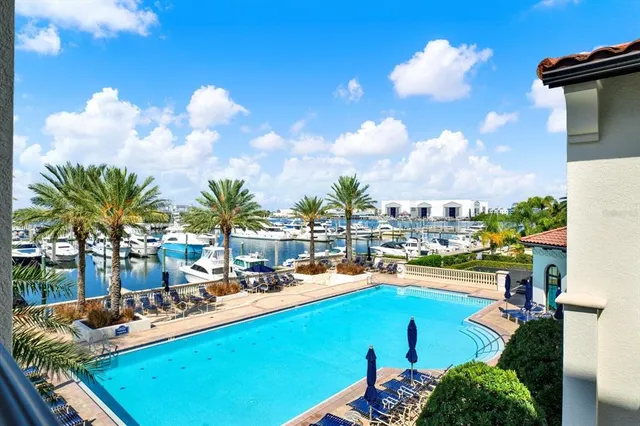 a view of a swimming pool and lounge chairs