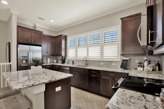 a kitchen with a sink stove and refrigerator