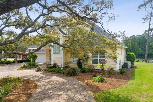 a front view of a house with a yard and trees