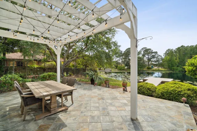 a view of a patio with a table chairs and a swimming pool