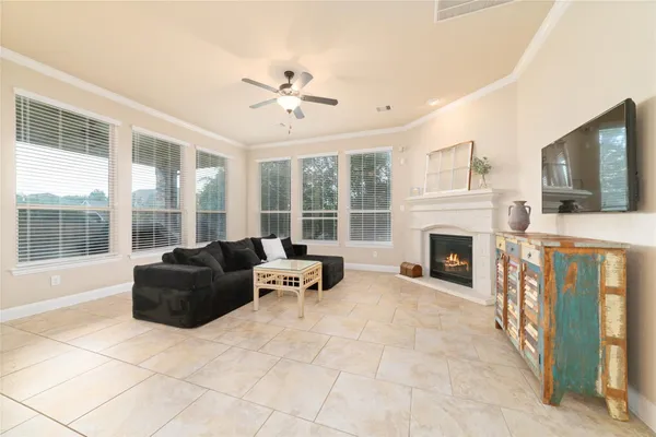 a living room with furniture a flat screen tv and a fireplace