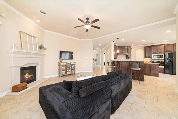 a living room with furniture kitchen view and a fireplace