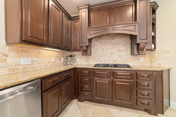 a kitchen with stainless steel appliances granite countertop a sink stove and cabinets