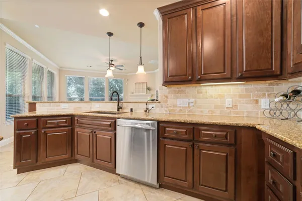 a kitchen with stainless steel appliances granite countertop wooden cabinets a sink and dishwasher