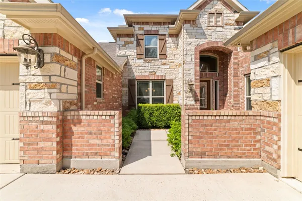a front view of a house with a parking area