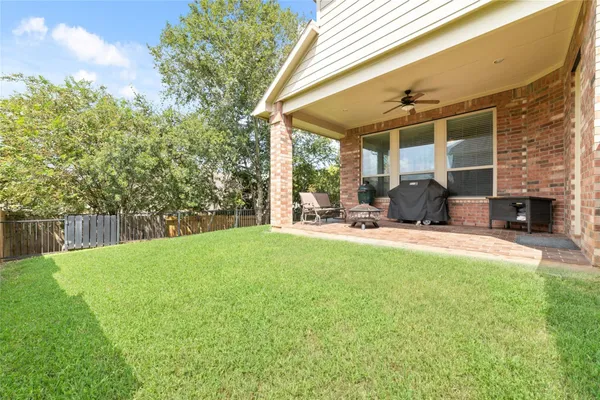 a view of a house with a yard and sitting area