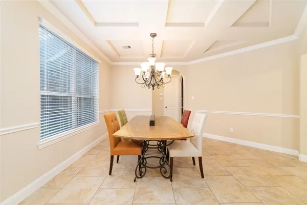 a dining room with furniture and window