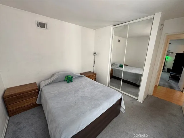 a bedroom with a bed and a walk in closet