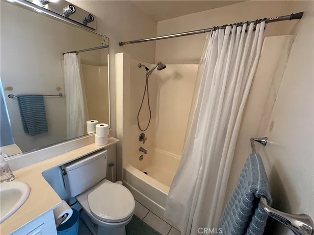 a white toilet sitting next to a bathroom sink and shower
