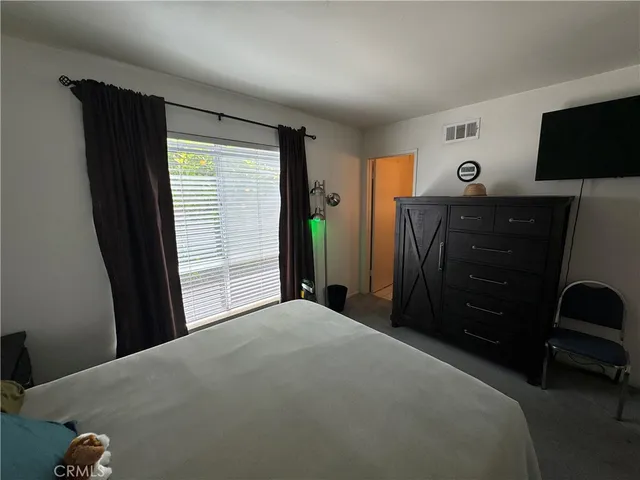 a bedroom with a bed and a dresser