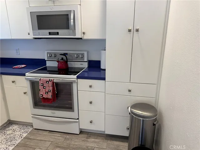 a kitchen with stainless steel appliances a stove and a microwave