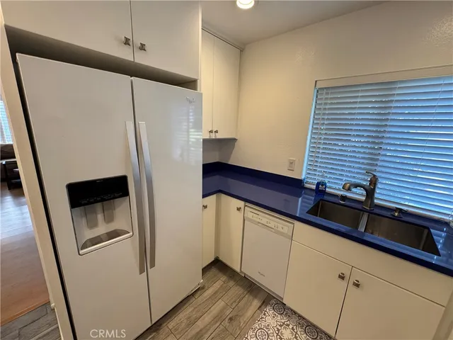 a kitchen with a refrigerator and a sink