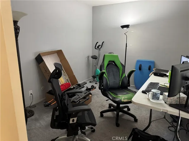 a view of a workspace with furniture and a gate