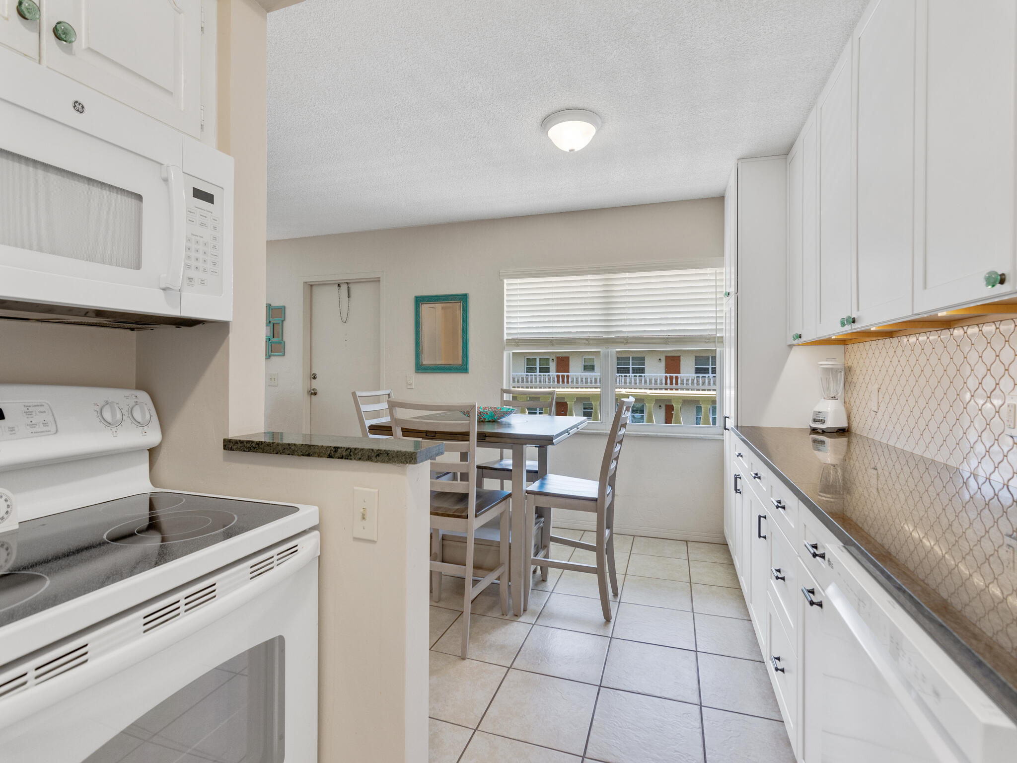 Undisclosed Address Vero Beach, FL 32960 - Photo 14 of 29 a kitchen with granite countertop cabinets a sink and a stove