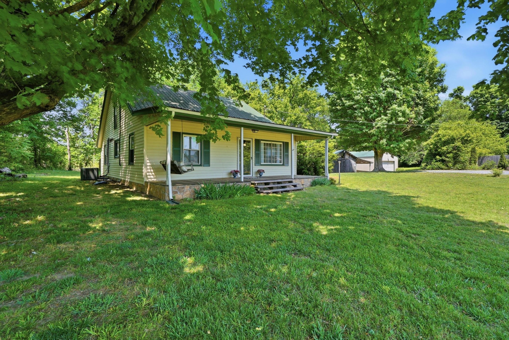 a front view of house with yard and green space