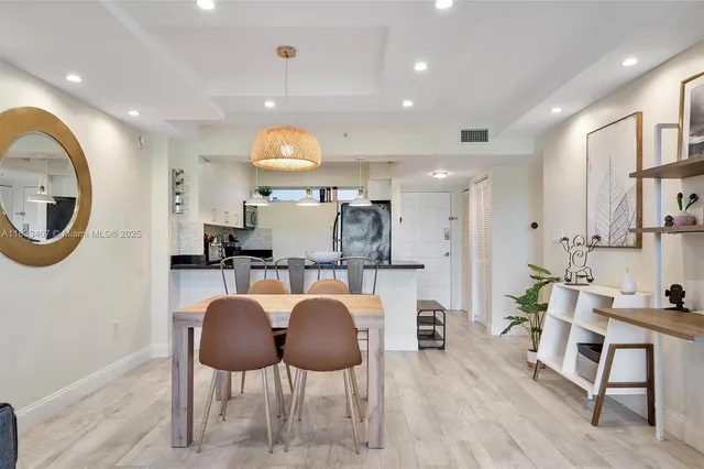 a large kitchen with a table and chairs