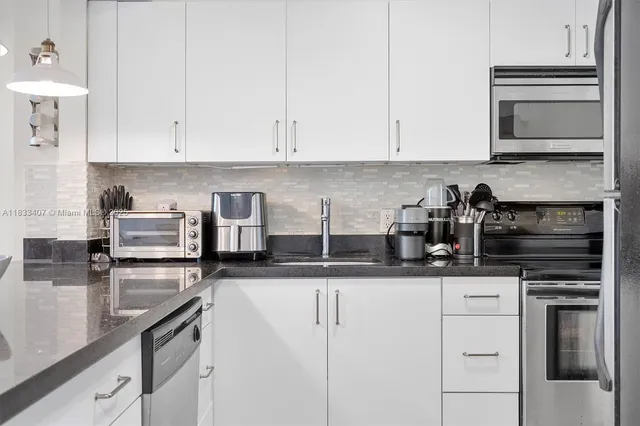 a kitchen with granite countertop a sink and cabinets
