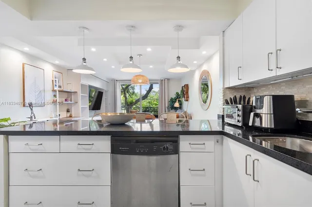 a kitchen with granite countertop a sink and cabinets