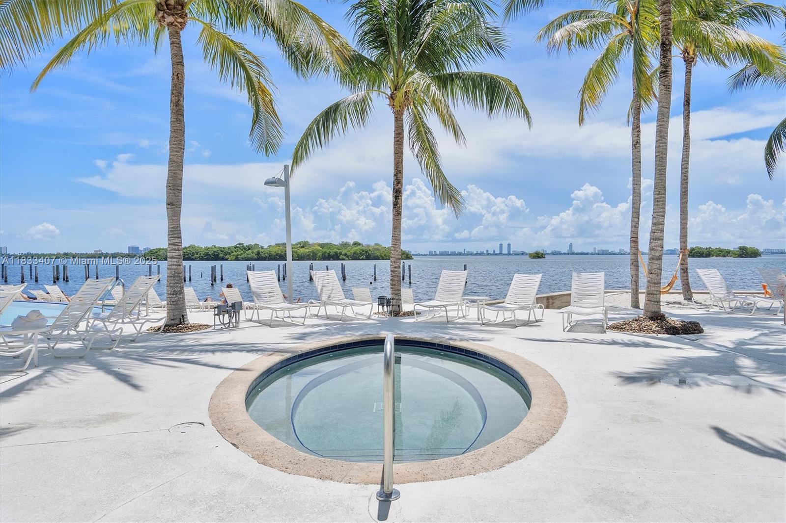 650 Northeast 64th Street, Unit G210 Miami, FL 33138 - Photo 21 of 25 a view of a backyard with a palm tree