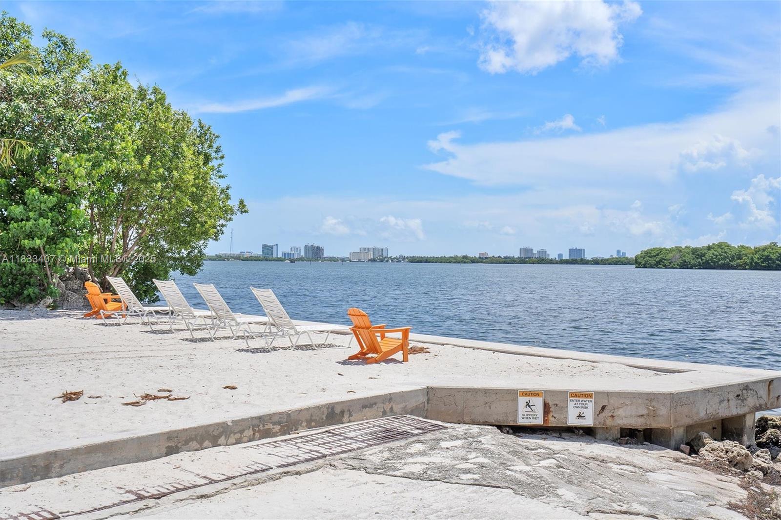 650 Northeast 64th Street, Unit G210 Miami, FL 33138 - Photo 23 of 25 a view of a swimming pool with a lounge chair