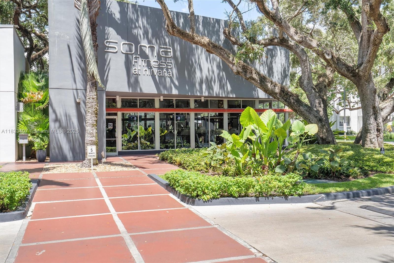 650 Northeast 64th Street, Unit G210 Miami, FL 33138 - Photo 25 of 25 a view of a building with a garden