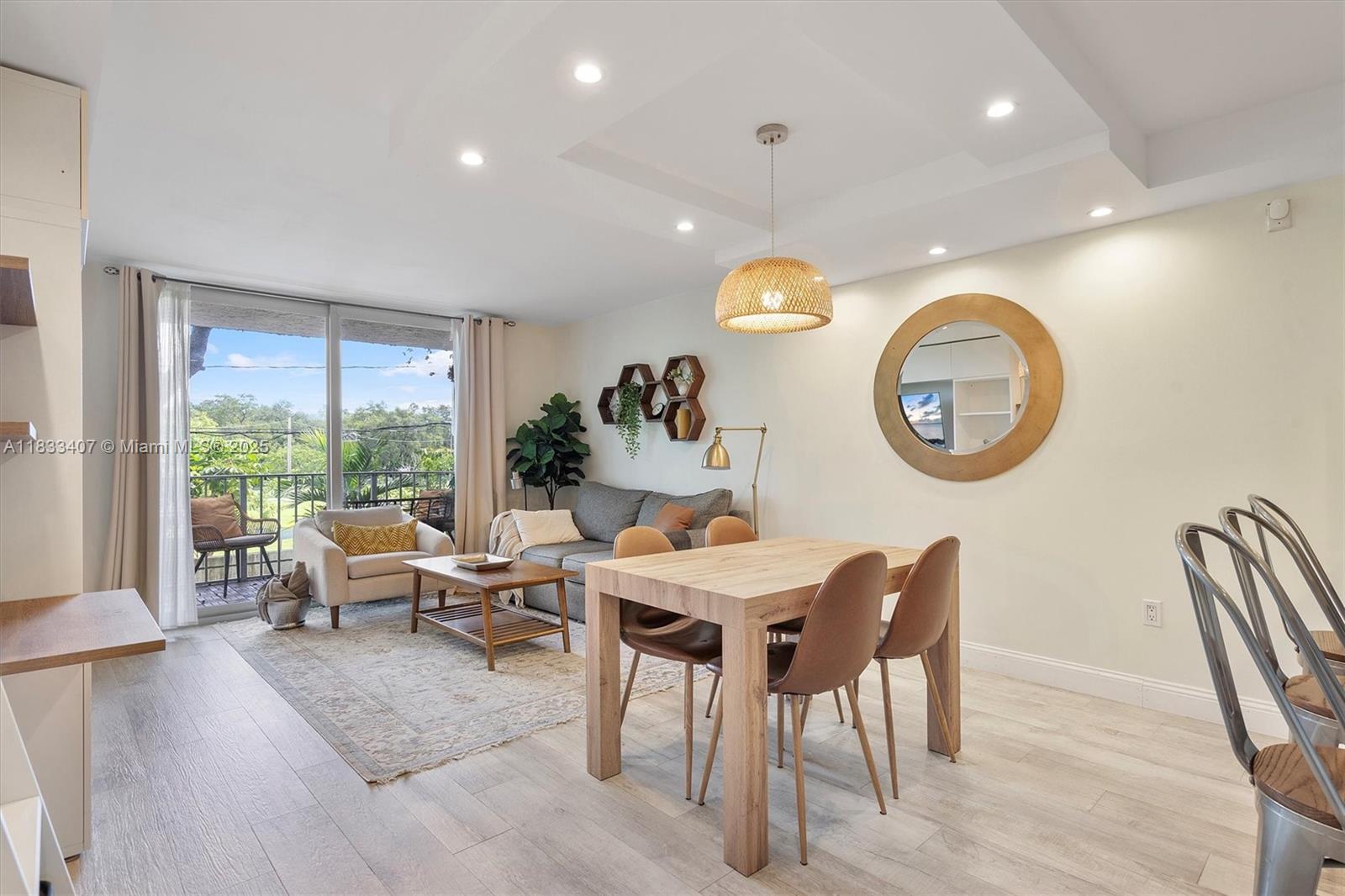 650 Northeast 64th Street, Unit G210 Miami, FL 33138 - Photo 10 of 25 a view of a dining room with furniture and a large window