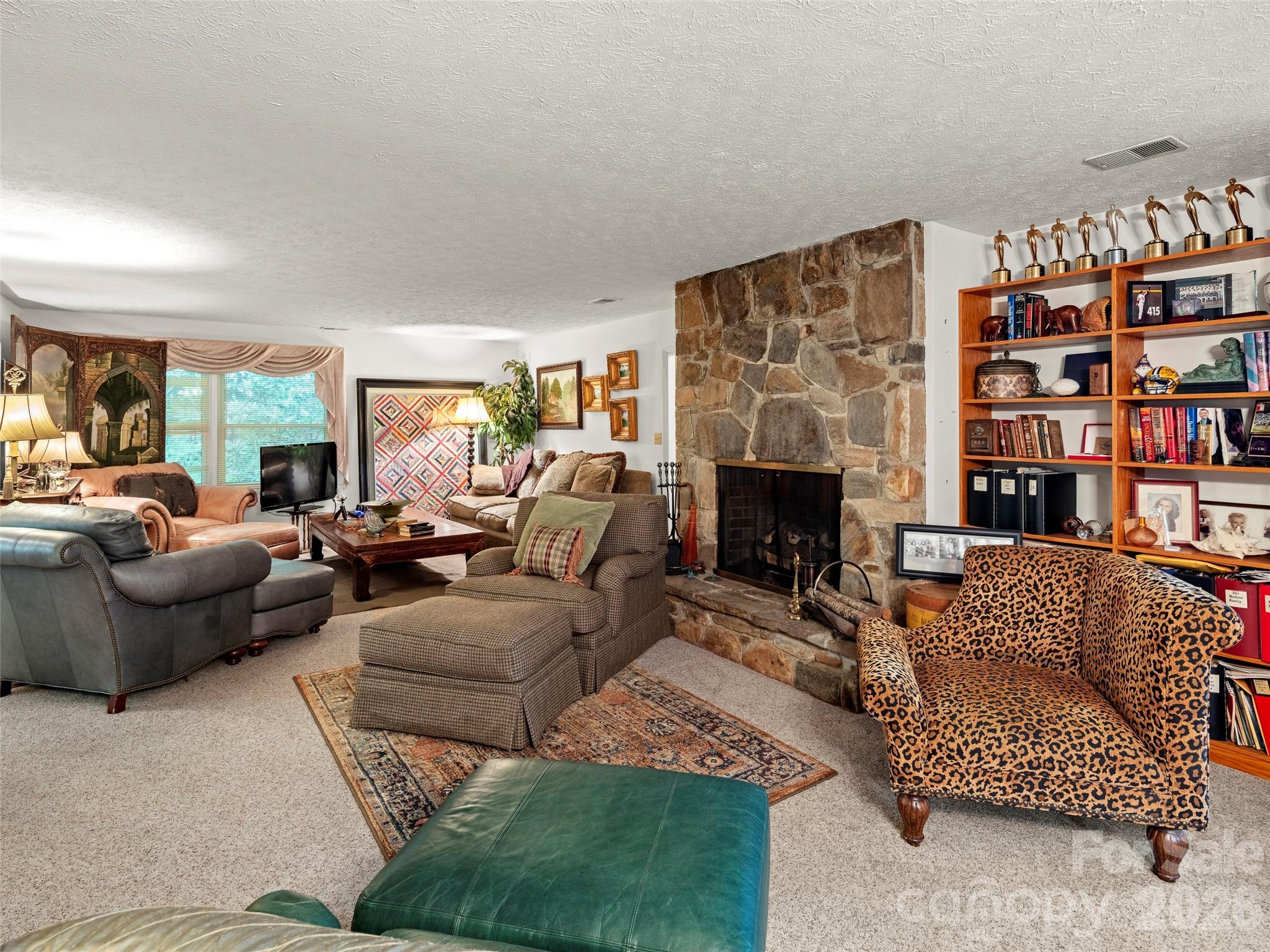 812 Crab Creek Road Hendersonville, NC 28739 - Photo 11 of 33 a living room with furniture and a fireplace