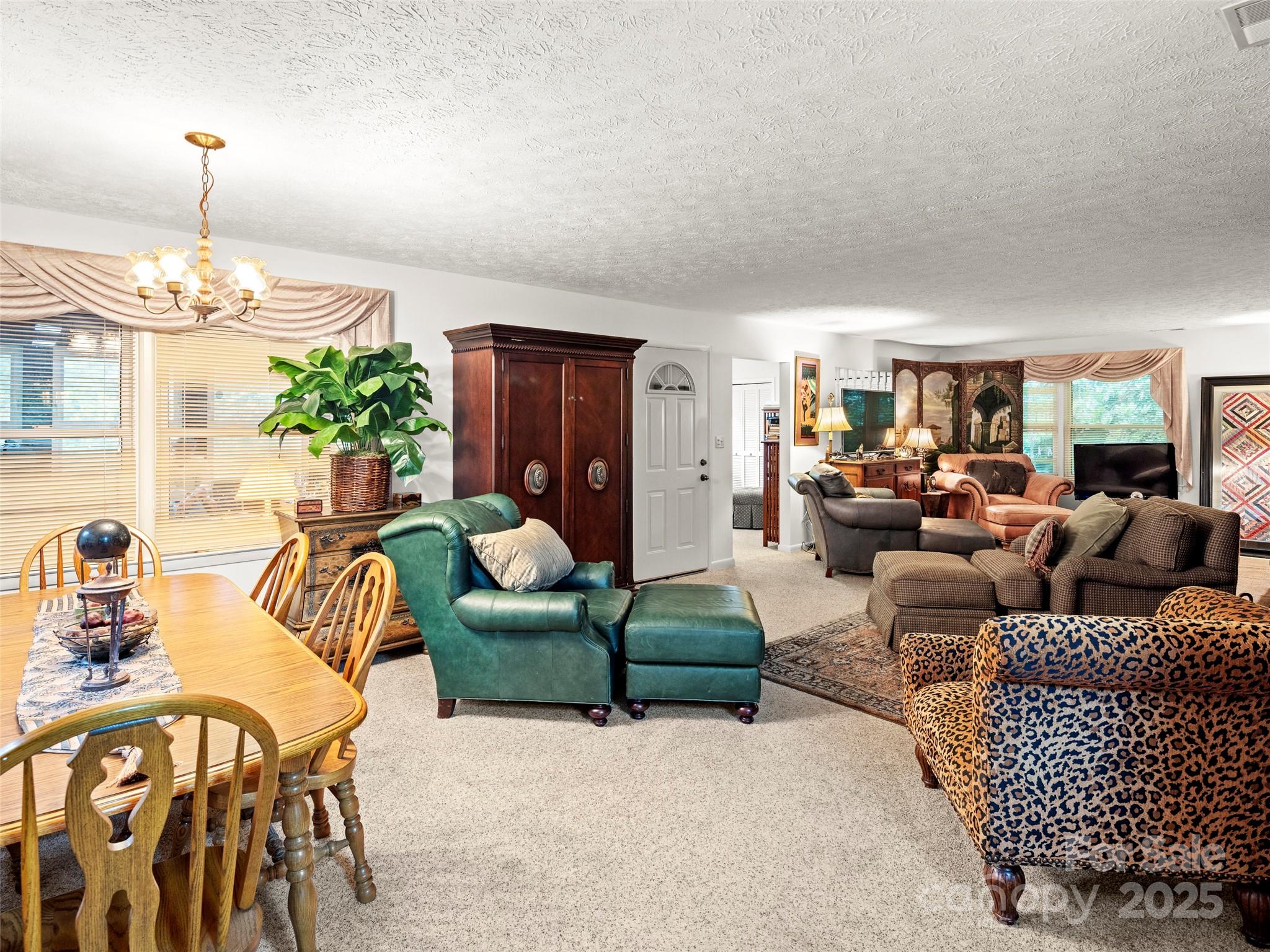 812 Crab Creek Road Hendersonville, NC 28739 - Photo 11 of 34 a living room with furniture and a chandelier