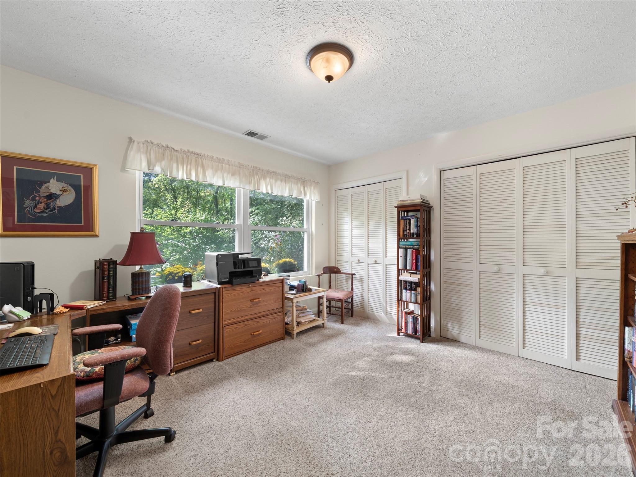 812 Crab Creek Road Hendersonville, NC 28739 - Photo 12 of 33 a view of a livingroom with workspace and a window