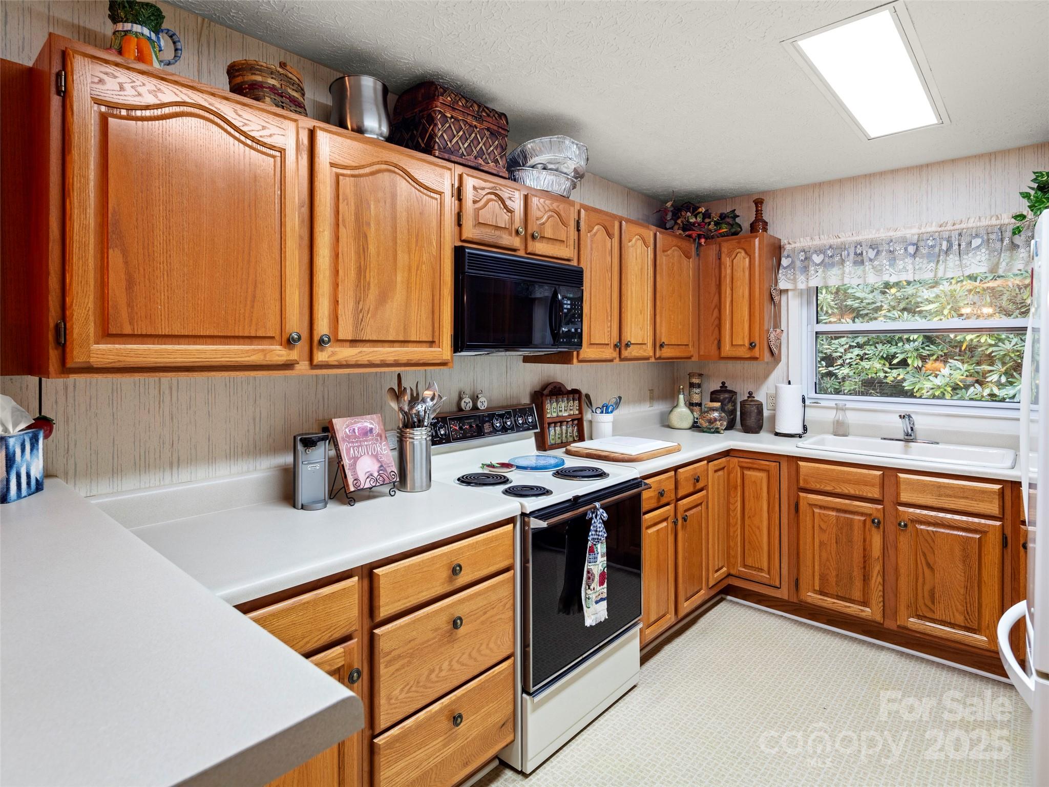 812 Crab Creek Road Hendersonville, NC 28739 - Photo 14 of 34 a kitchen with stainless steel appliances granite countertop a sink stove and cabinets