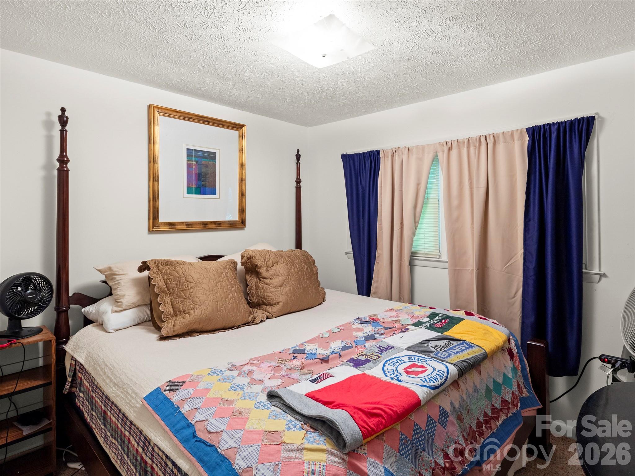 812 Crab Creek Road Hendersonville, NC 28739 - Photo 15 of 33 a bedroom with a bed and a dresser