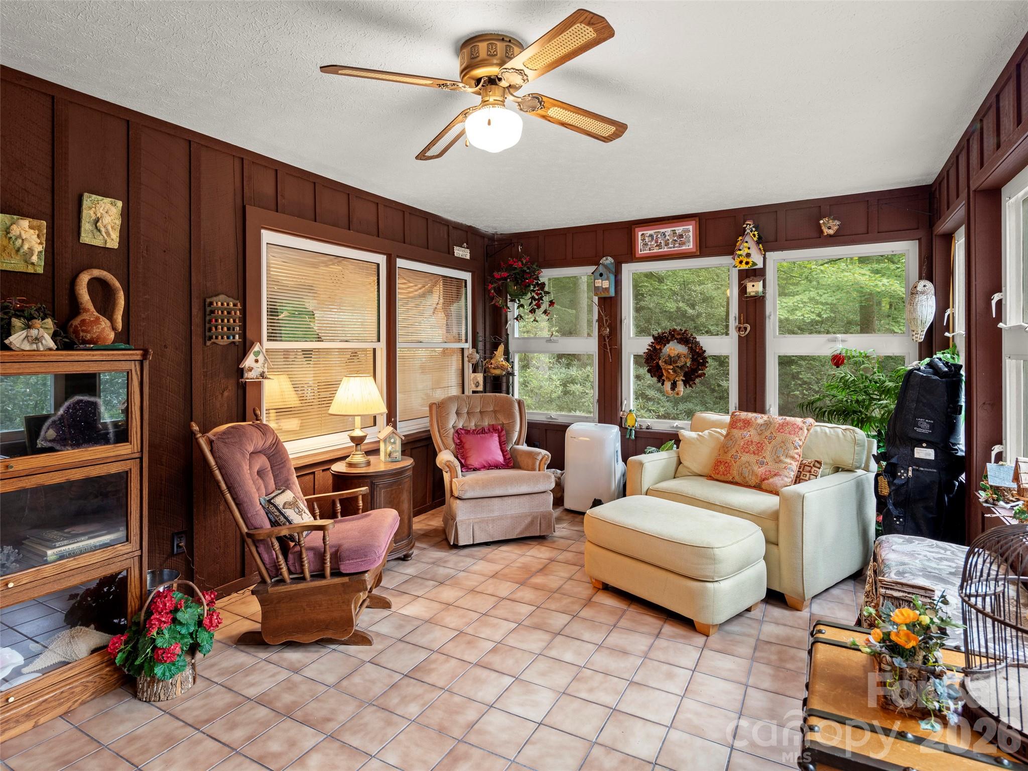 812 Crab Creek Road Hendersonville, NC 28739 - Photo 17 of 33 a living room with furniture and a floor to ceiling window