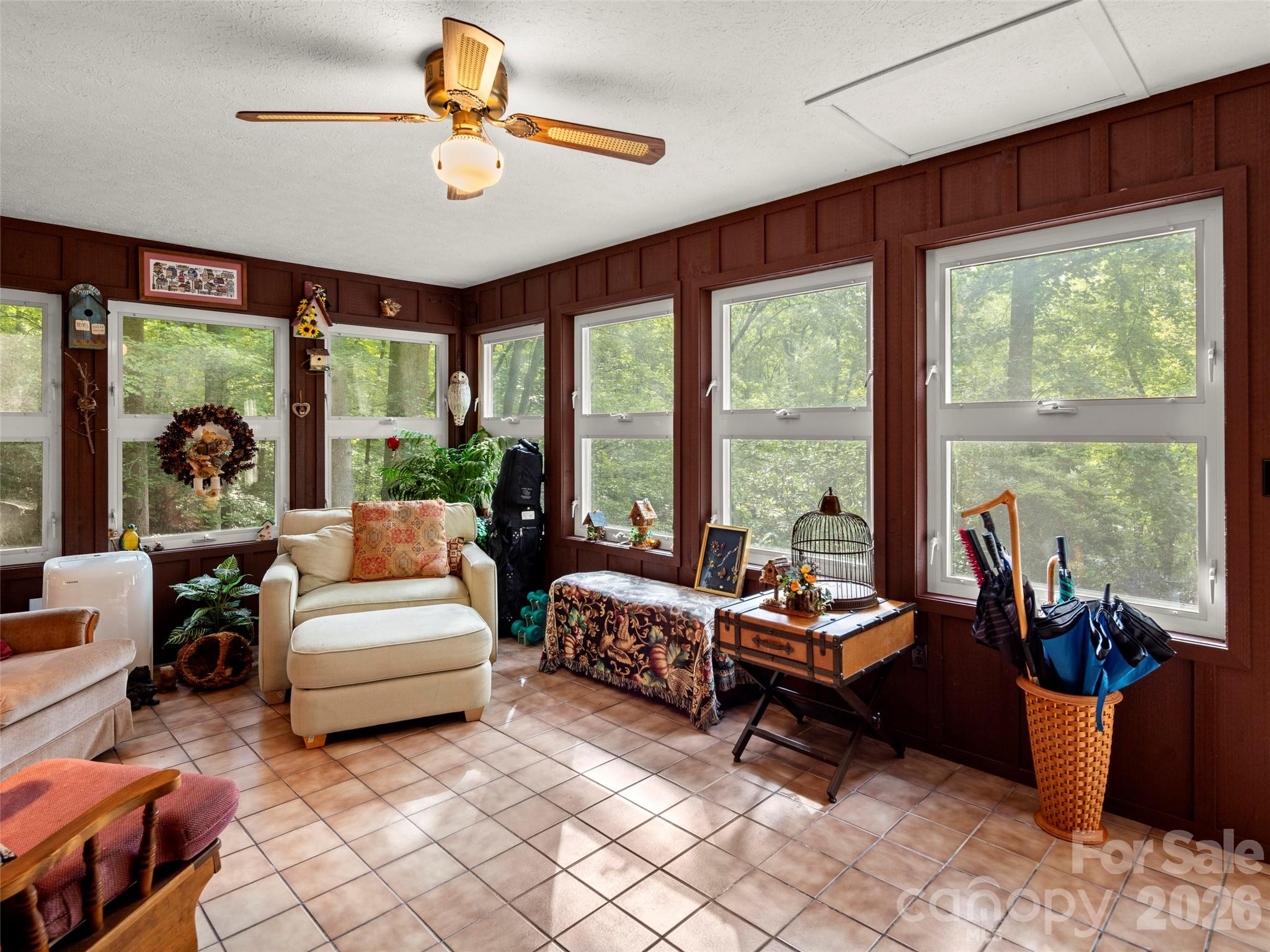 812 Crab Creek Road Hendersonville, NC 28739 - Photo 18 of 33 a living room with furniture and floor to ceiling windows