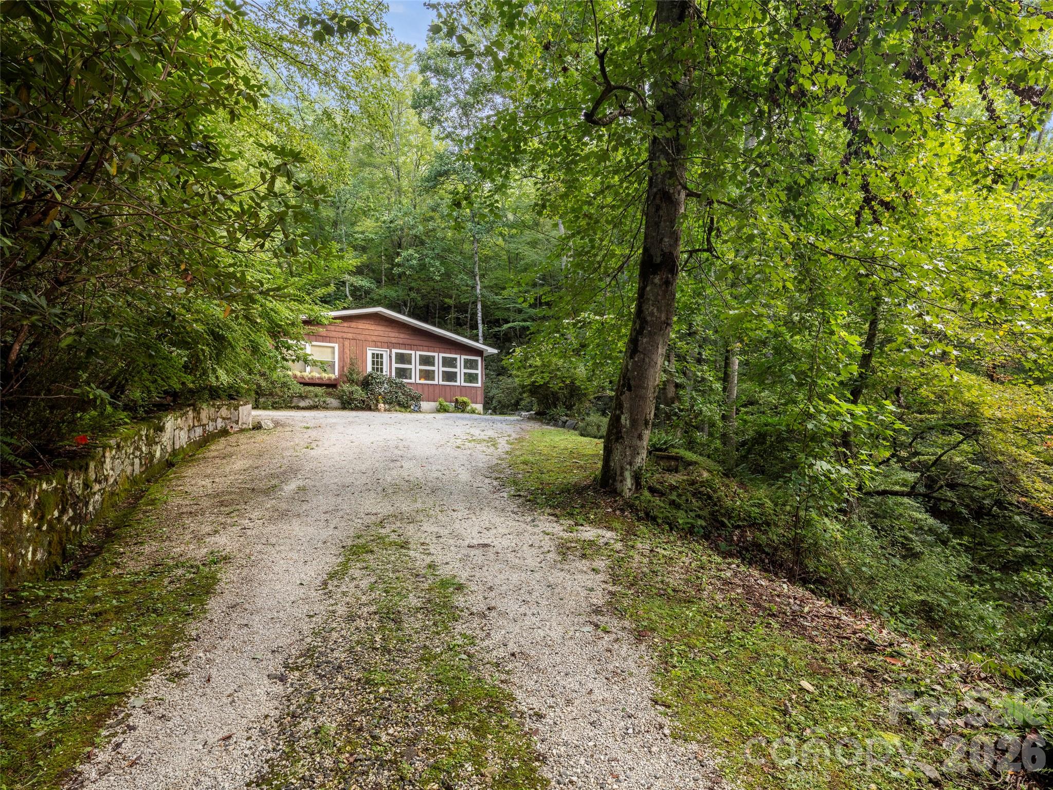 812 Crab Creek Road Hendersonville, NC 28739 - Photo 21 of 33 a house with trees in front of it