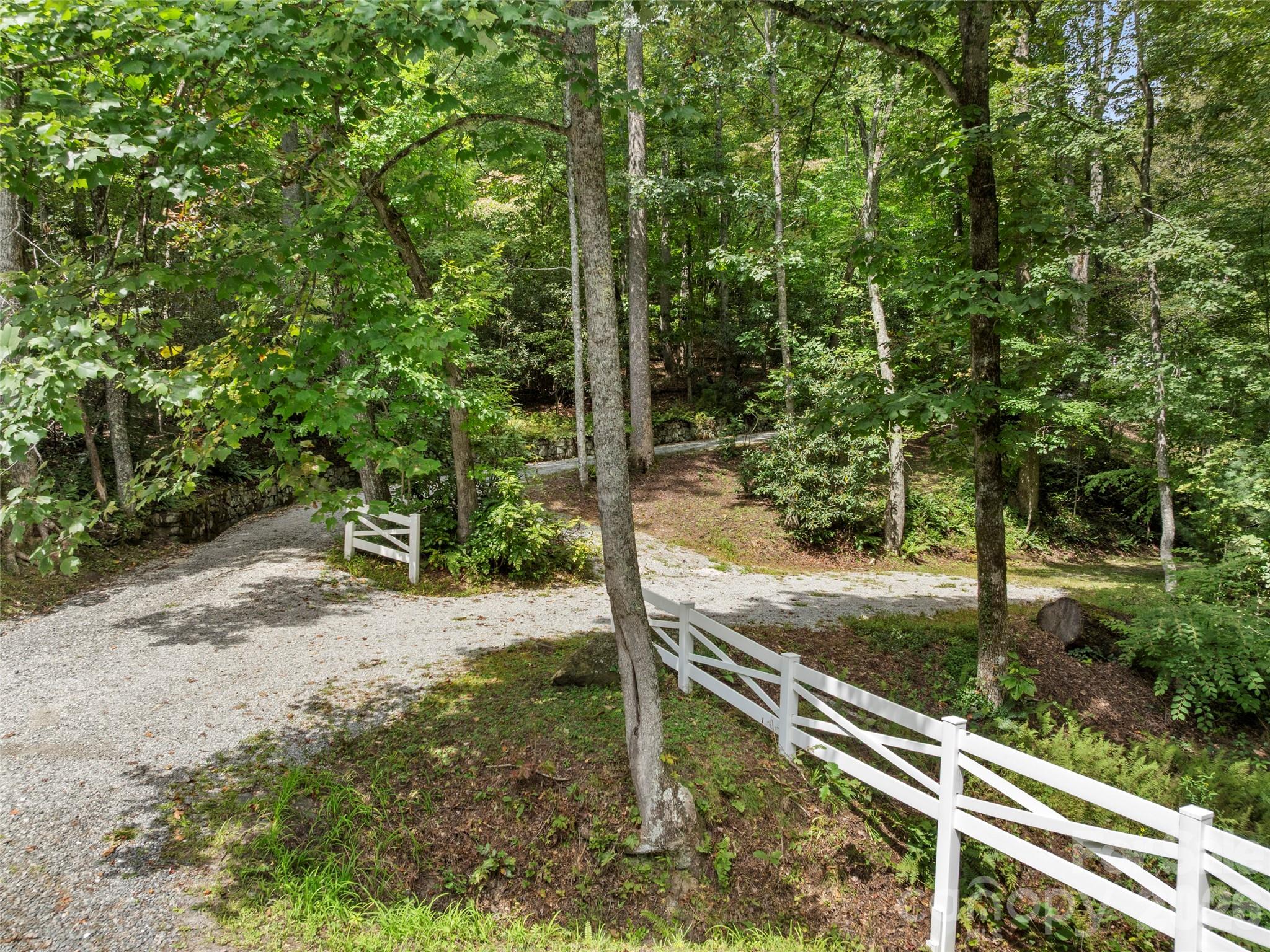 812 Crab Creek Road Hendersonville, NC 28739 - Photo 22 of 33 a view of a wooden fence under a large tree