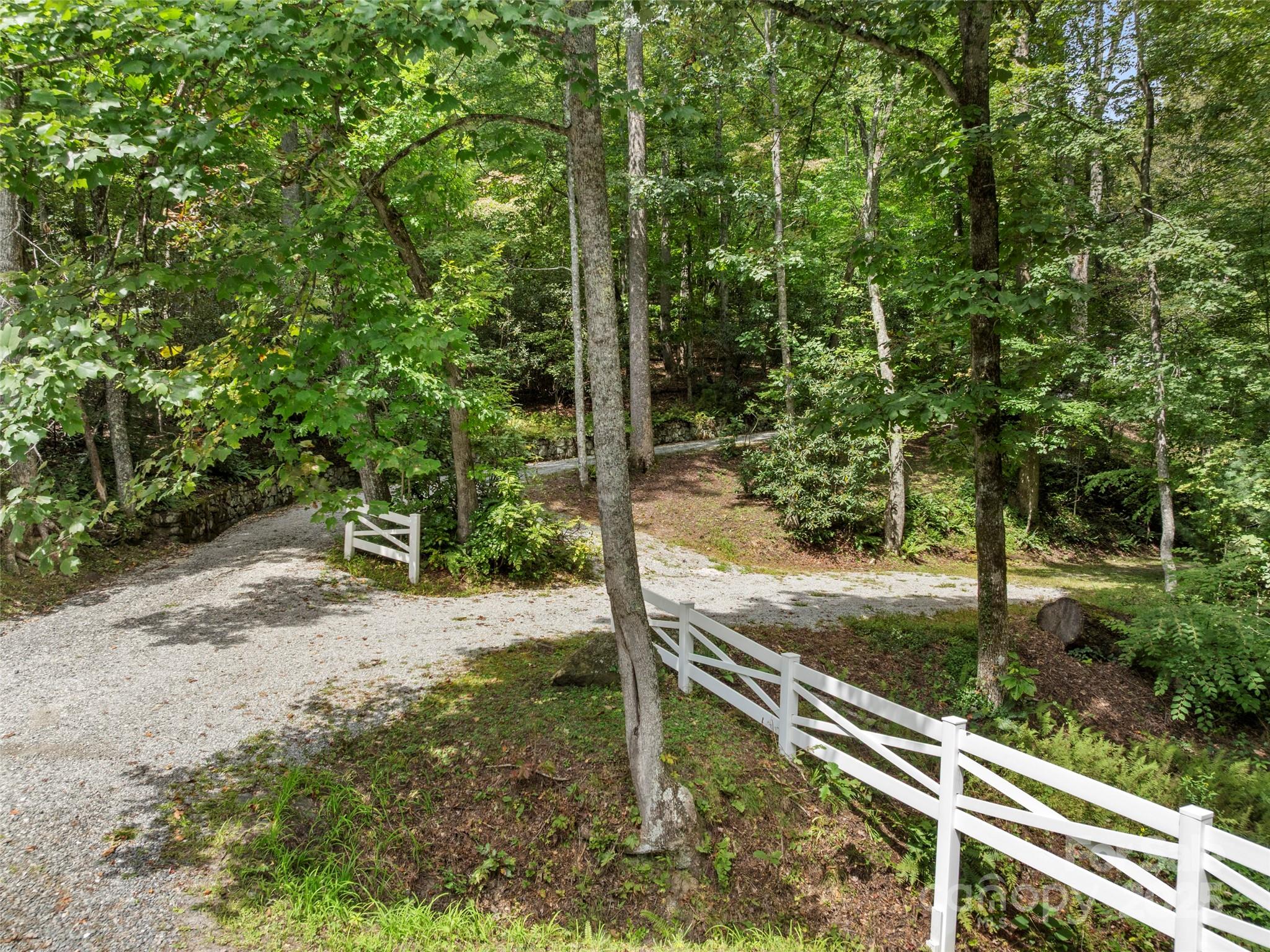 812 Crab Creek Road Hendersonville, NC 28739 - Photo 23 of 34 a view of a wooden fence under a large tree