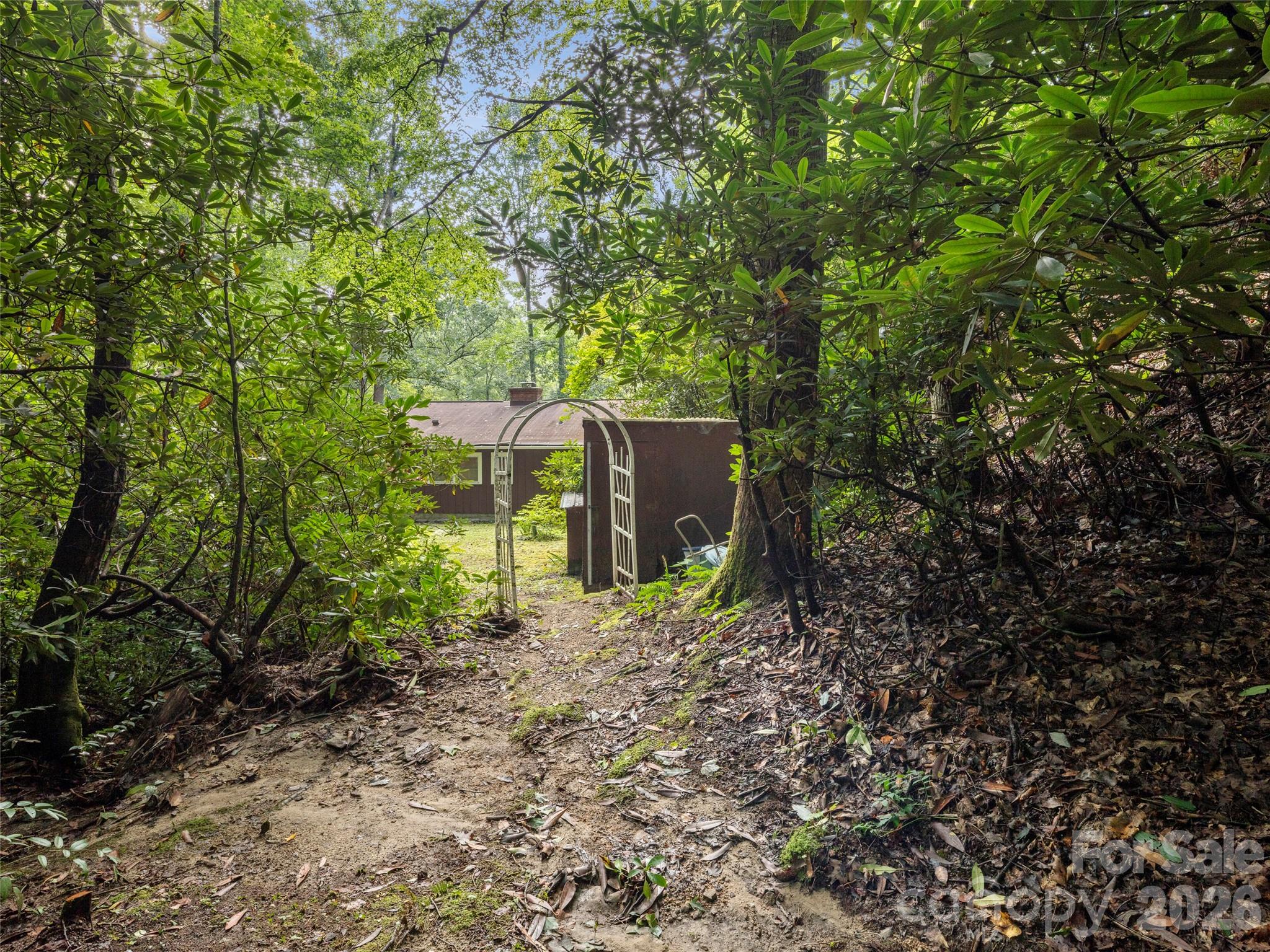 812 Crab Creek Road Hendersonville, NC 28739 - Photo 24 of 33 a backyard of a house with lots of green space