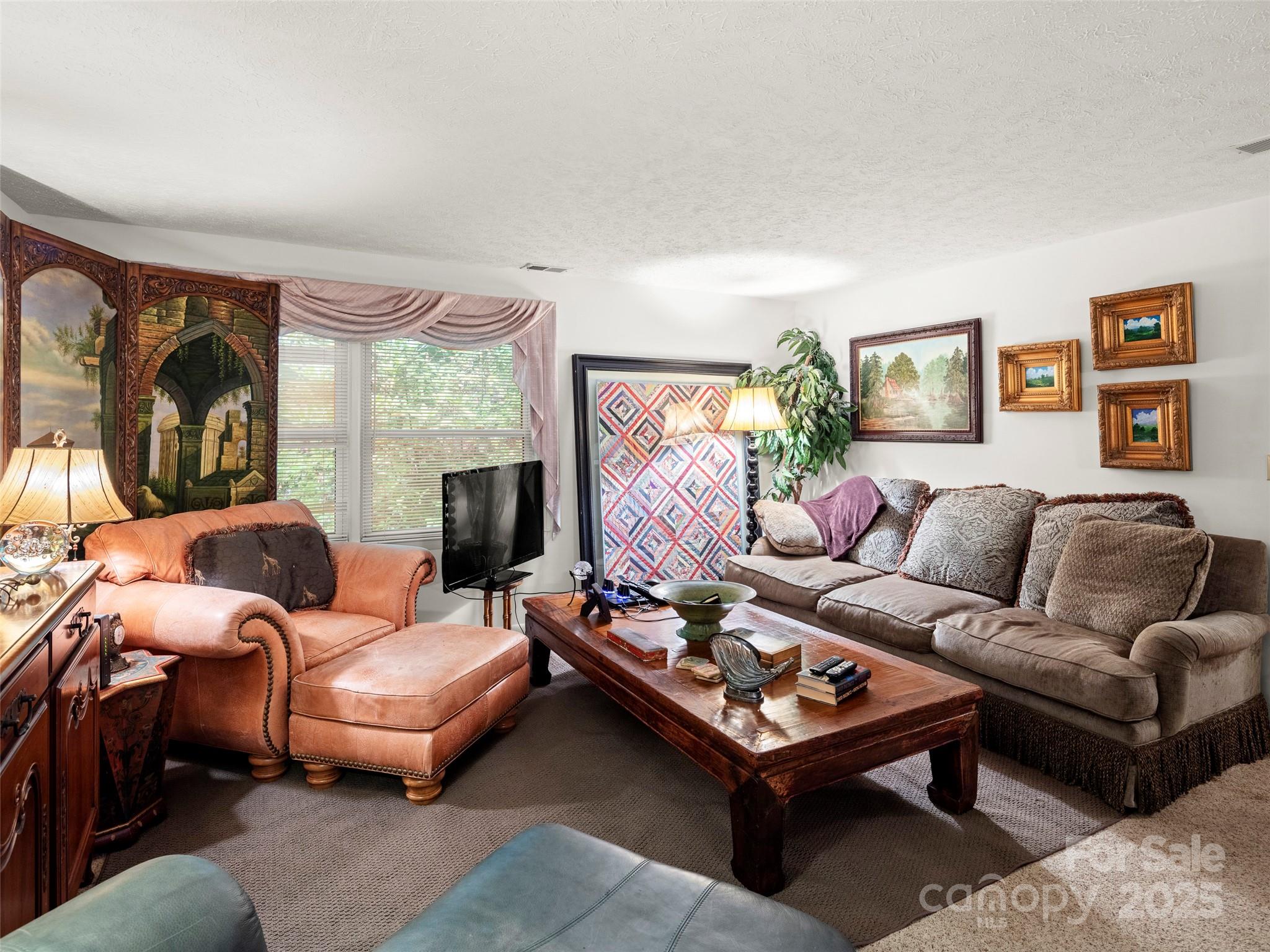 812 Crab Creek Road Hendersonville, NC 28739 - Photo 9 of 34 a living room with furniture and a floor to ceiling window