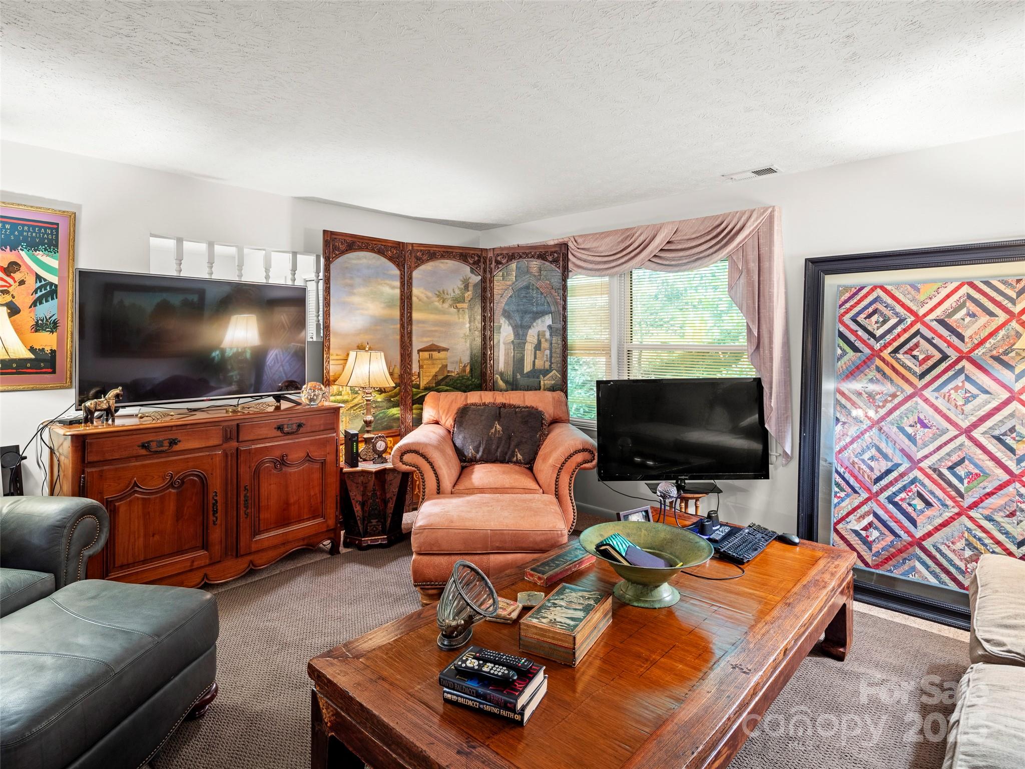812 Crab Creek Road Hendersonville, NC 28739 - Photo 10 of 34 a living room with furniture and a flat screen tv