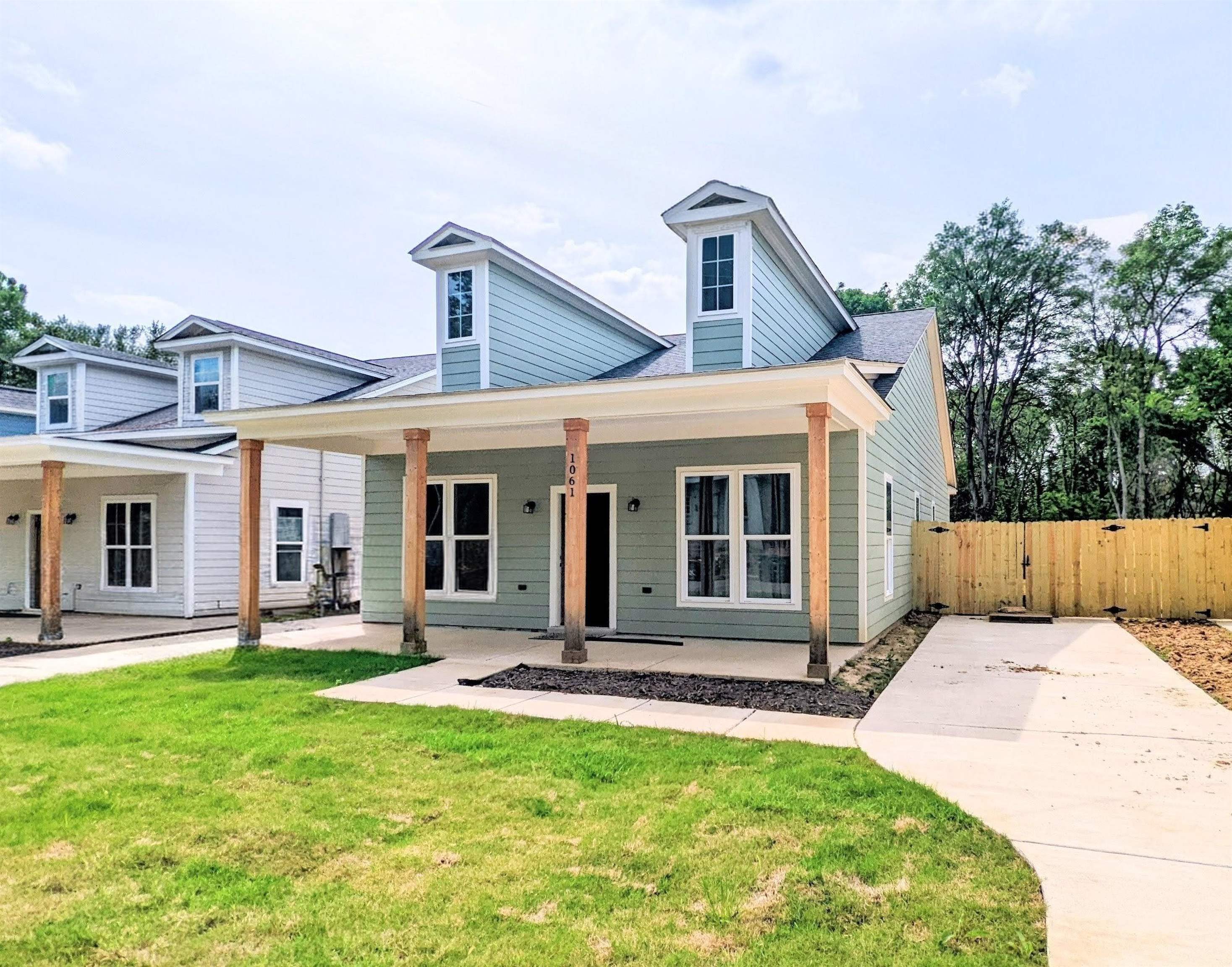a front view of a house with a yard table and chairs