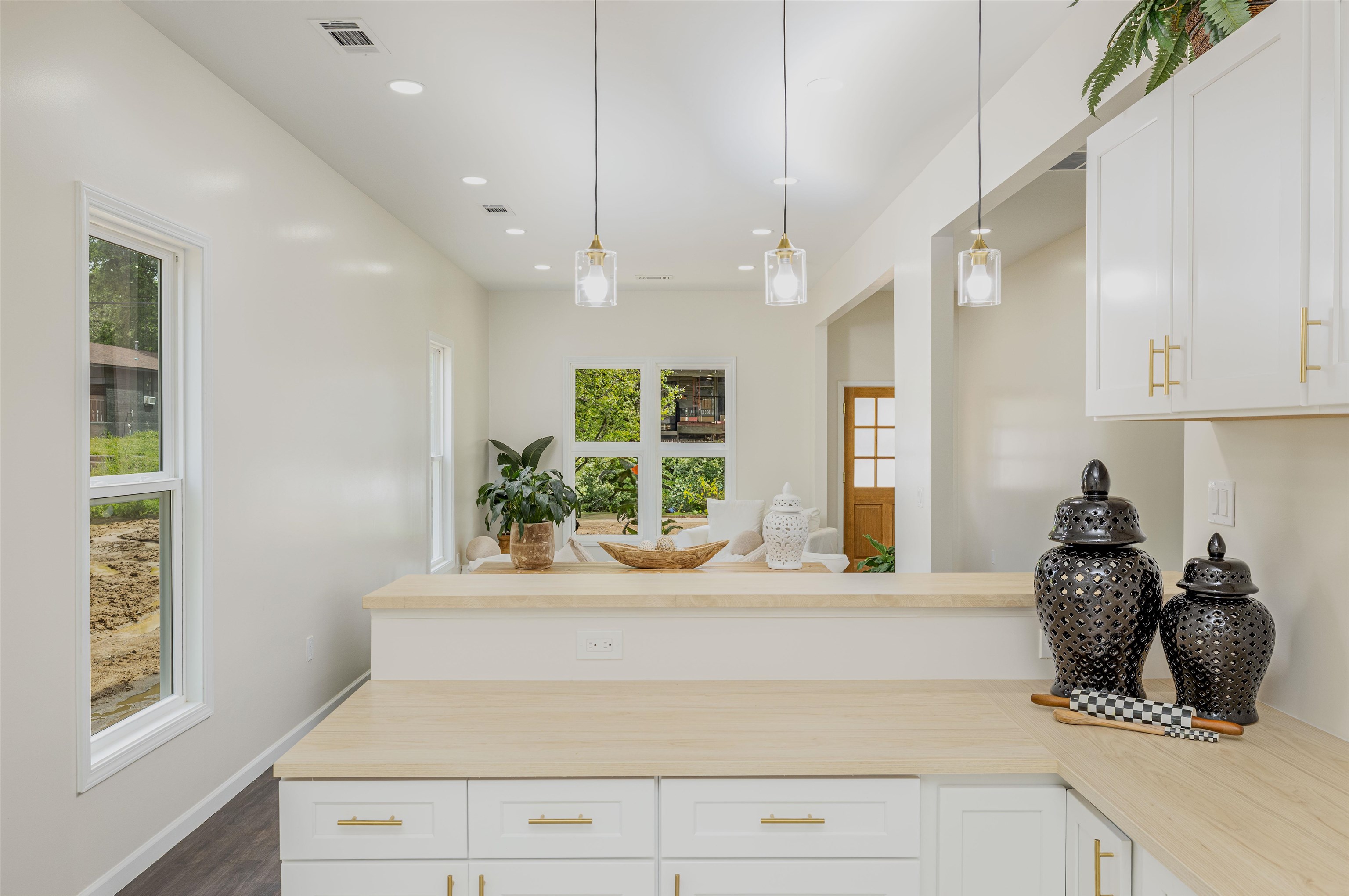 1069 Shaw Place Memphis, TN 38126 - Photo 23 of 23 Kitchen with a peninsula, visible vents, white cabinets, and open floor plan