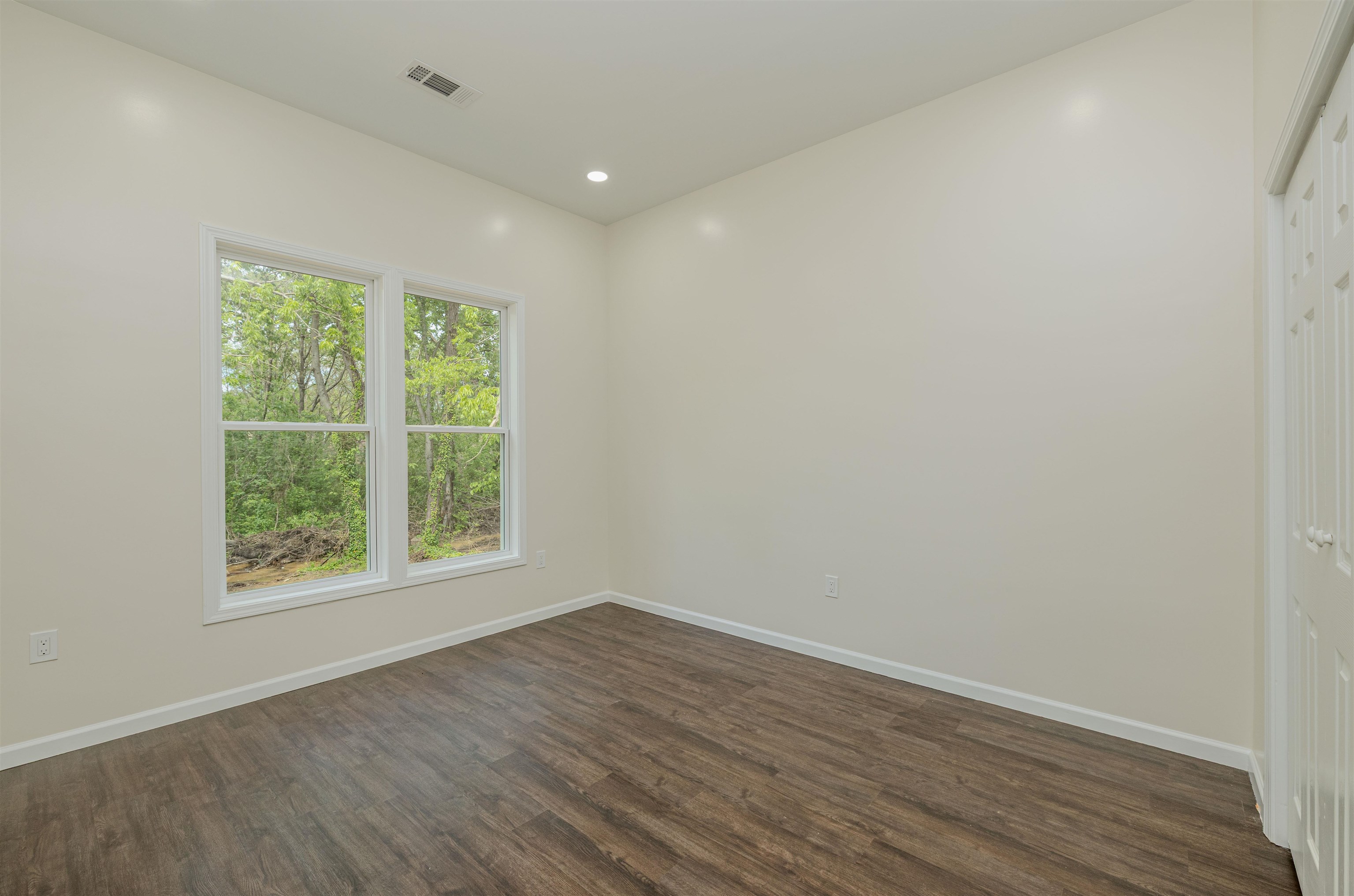 1069 Shaw Place Memphis, TN 38126 - Photo 12 of 23 an empty room with wooden floor and windows