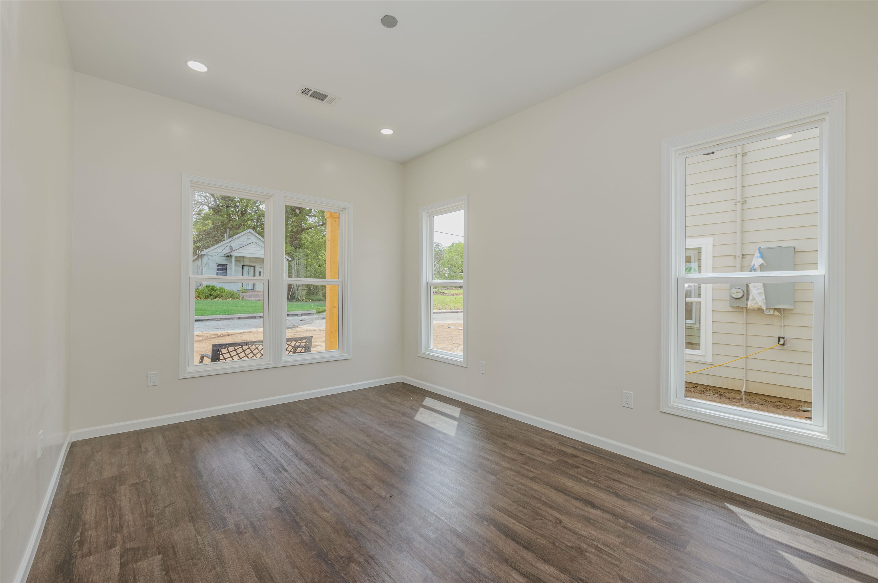 1069 Shaw Place Memphis, TN 38126 - Photo 14 of 23 an empty room with wooden floor and windows