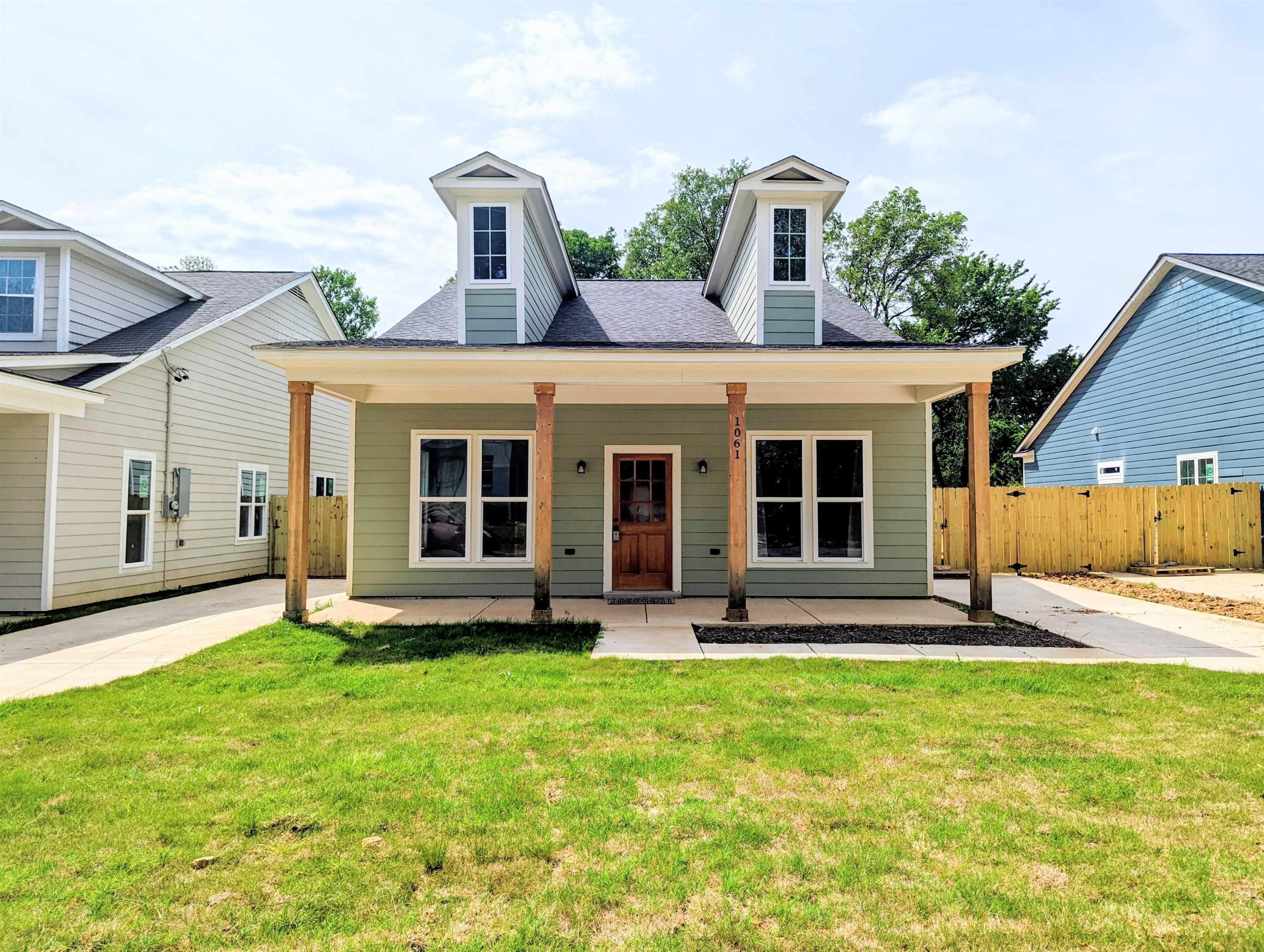 1069 Shaw Place Memphis, TN 38126 - Photo 2 of 23 a front view of a house with a garden and plants