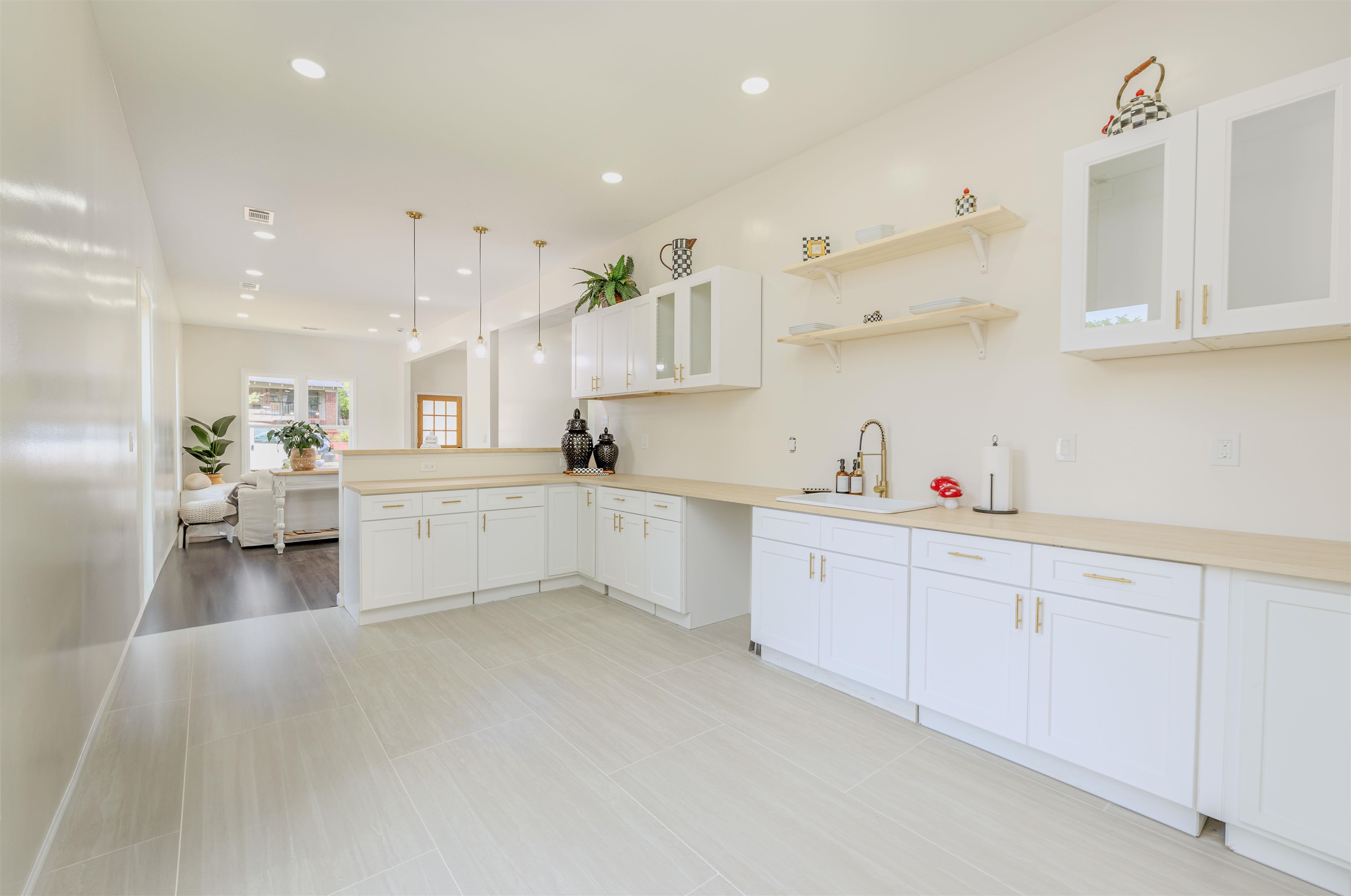 1069 Shaw Place Memphis, TN 38126 - Photo 8 of 23 a large white kitchen with lots of counter space wooden floor and appliances