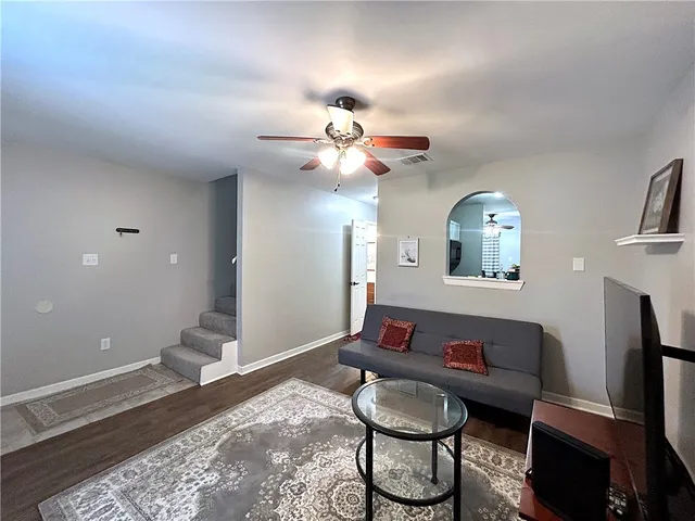 a living room with furniture and a chandelier