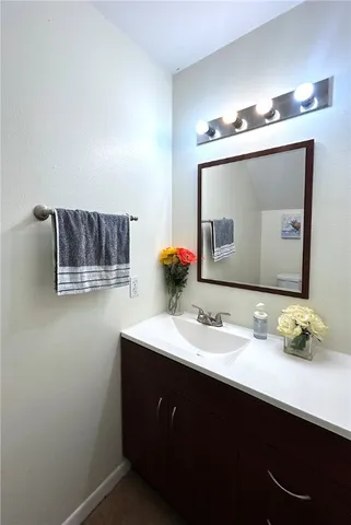 a bathroom with a sink vanity and mirror